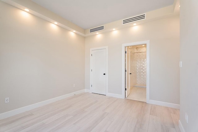 unfurnished room with light hardwood / wood-style floors