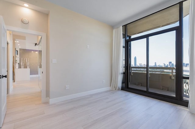 empty room with light hardwood / wood-style floors