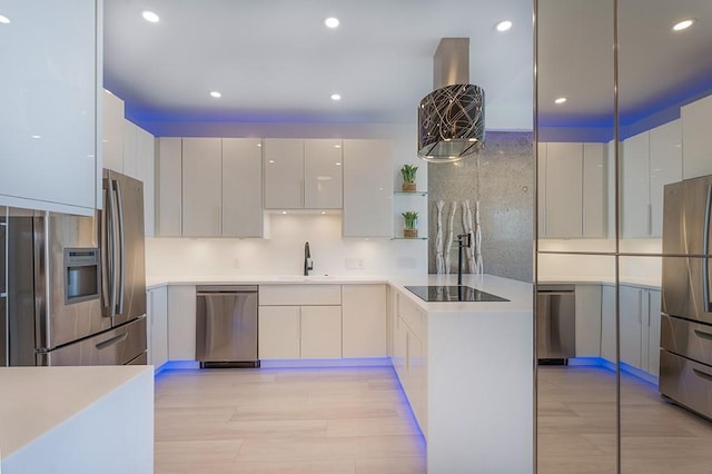 kitchen with sink, light hardwood / wood-style flooring, white cabinetry, stainless steel appliances, and decorative backsplash