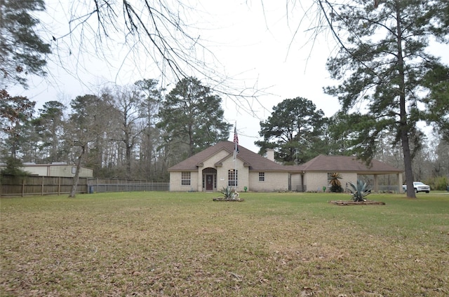 view of front of property with fence and a front lawn