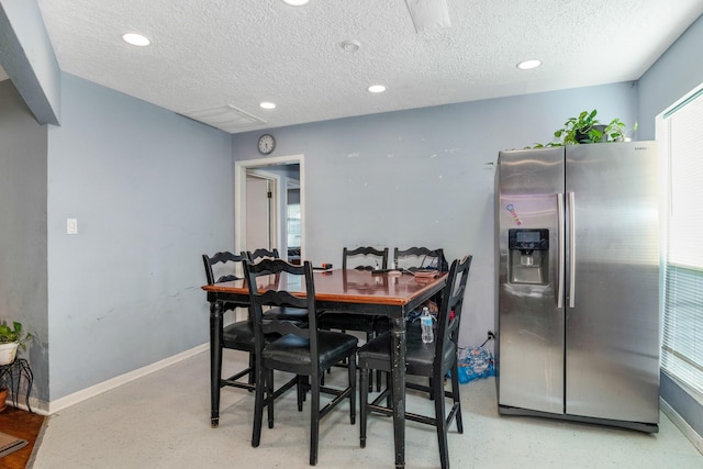 dining area featuring a textured ceiling