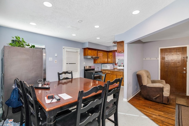 dining space with a textured ceiling