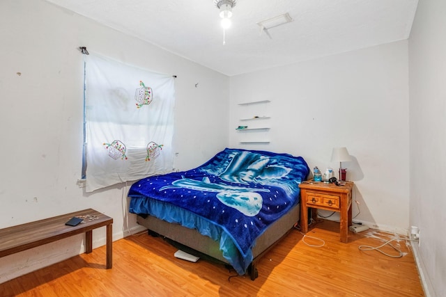 bedroom with wood-type flooring