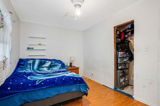 bedroom with hardwood / wood-style flooring and ceiling fan