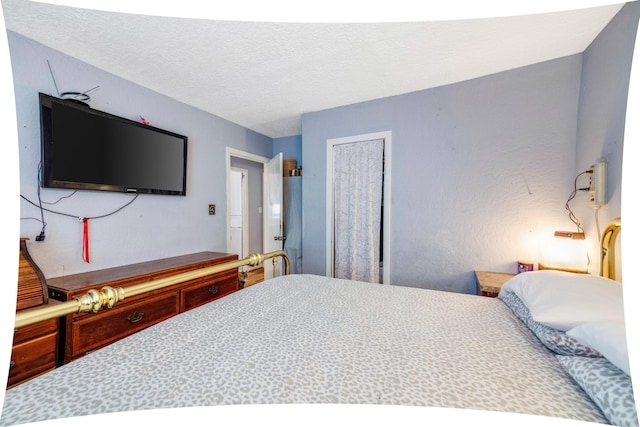 bedroom featuring a textured ceiling and a closet