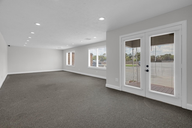 unfurnished room featuring dark colored carpet, french doors, recessed lighting, and baseboards