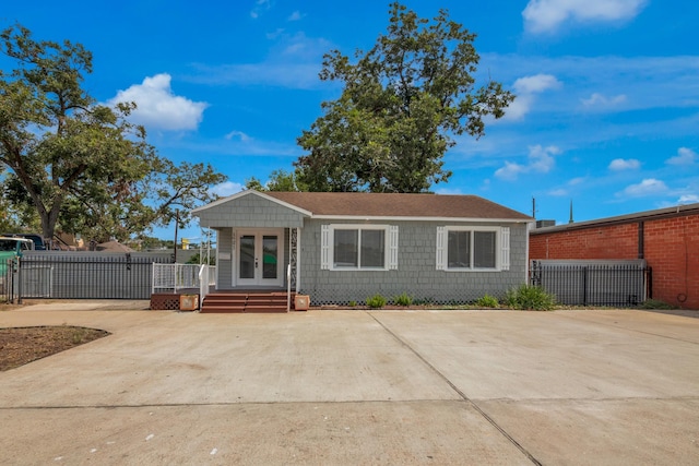 view of front of property featuring french doors, fence, and a gate