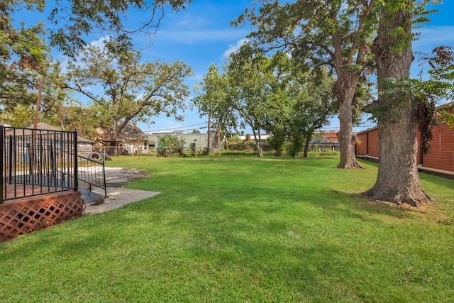 view of yard featuring fence and a wooden deck