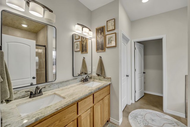 bathroom with vanity and a shower with shower door