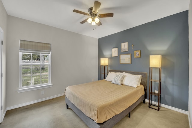 bedroom featuring light colored carpet and ceiling fan