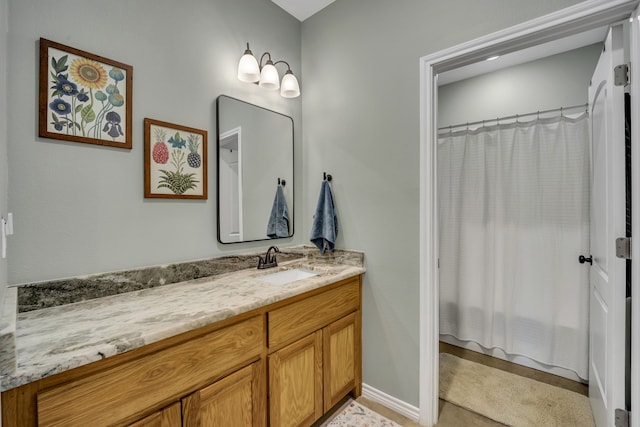 bathroom featuring vanity and a shower with shower curtain