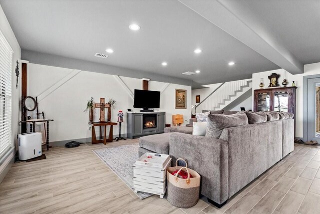 308 Lakeshore S, Onalaska, TX 77360 - living area with stairway, light wood-style floors, recessed lighting, baseboards, and a lit fireplace