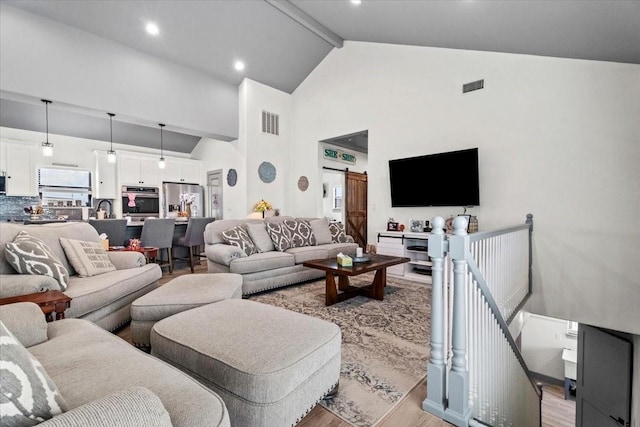 308 Lakeshore S, Onalaska, TX 77360 - living room featuring visible vents, beam ceiling, light wood-type flooring, and high vaulted ceiling
