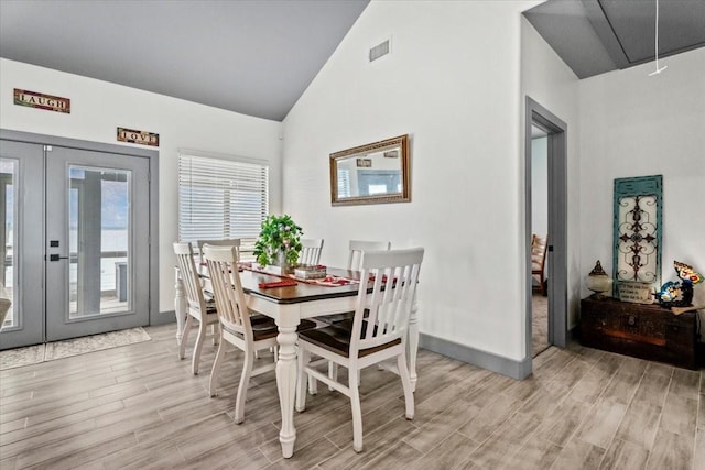 308 Lakeshore S, Onalaska, TX 77360 - dining area with french doors, attic access, baseboards, light wood finished floors, and high vaulted ceiling