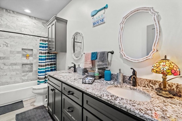 308 Lakeshore S, Onalaska, TX 77360 - bathroom with double vanity, toilet, shower / bathtub combination with curtain, and a sink