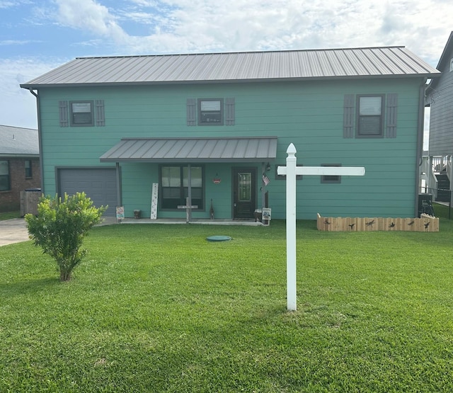 308 Lakeshore S, Onalaska, TX 77360 - back of house featuring covered porch, a yard, metal roof, and a garage
