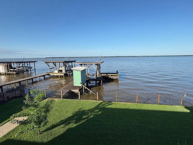 308 Lakeshore S, Onalaska, TX 77360 - dock area featuring boat lift, a water view, fence, and a lawn