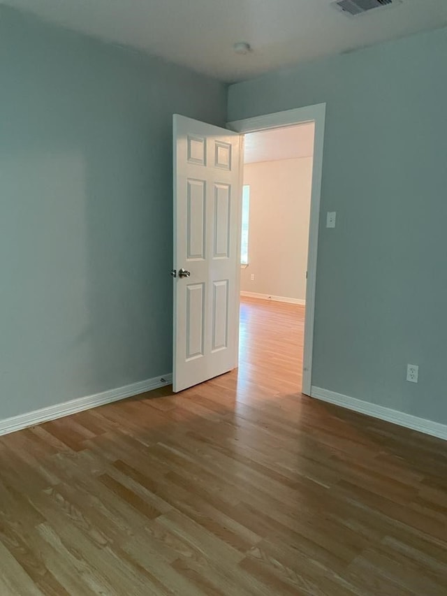 empty room with light hardwood / wood-style flooring