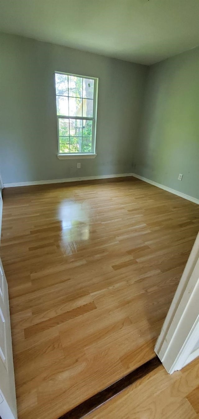 unfurnished room featuring light hardwood / wood-style floors