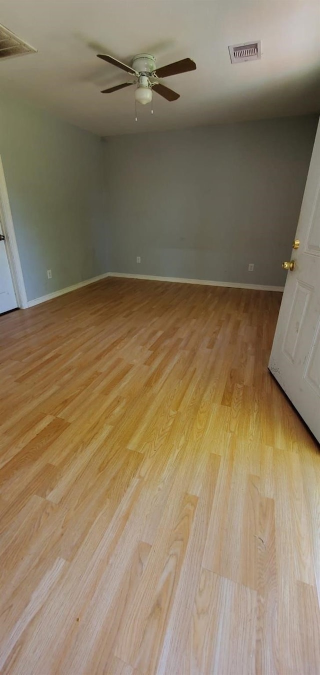 empty room featuring ceiling fan and light wood-type flooring