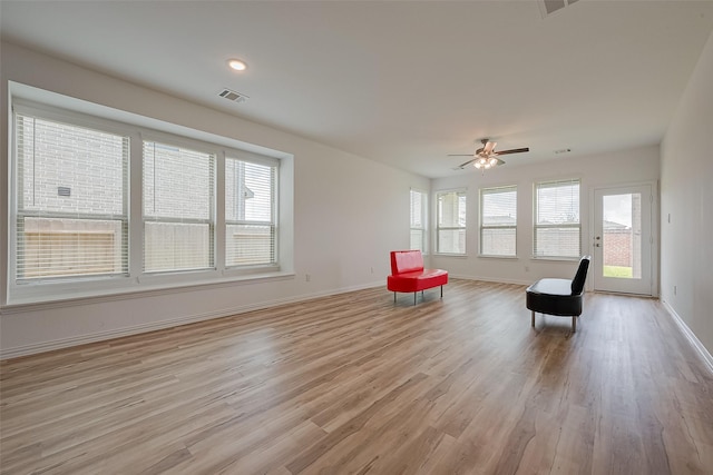 sitting room featuring ceiling fan, plenty of natural light, and light hardwood / wood-style floors