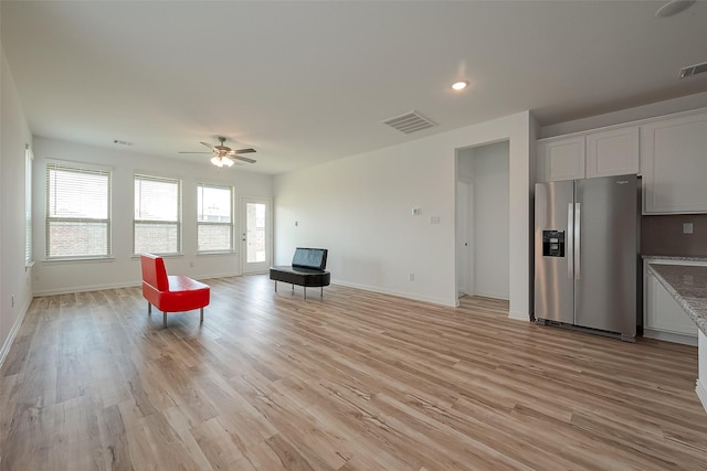 unfurnished room featuring ceiling fan and light wood-type flooring