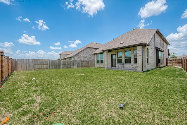 rear view of house with a patio area and a lawn