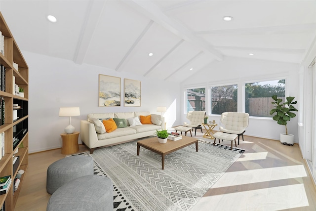 living room with light hardwood / wood-style flooring and lofted ceiling with beams