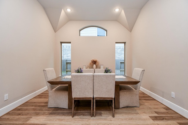 dining room featuring vaulted ceiling and hardwood / wood-style floors