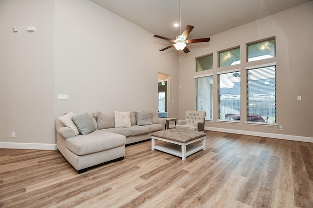 living room featuring ceiling fan, a healthy amount of sunlight, and light hardwood / wood-style floors