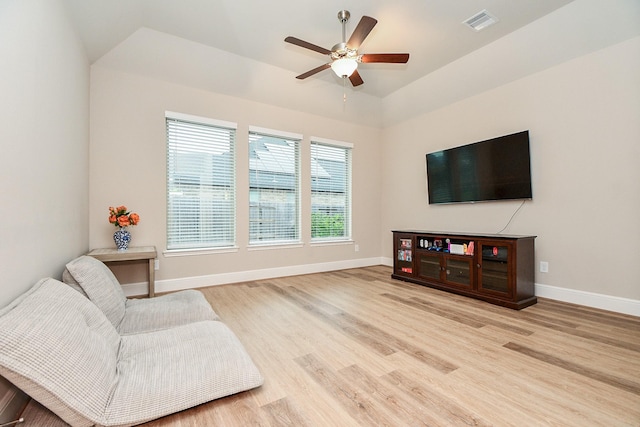 living room featuring ceiling fan and light hardwood / wood-style flooring