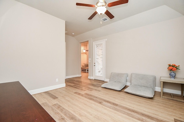 sitting room with ceiling fan and light wood-type flooring