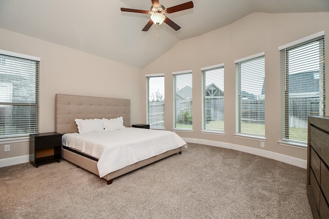 carpeted bedroom featuring multiple windows, vaulted ceiling, and ceiling fan