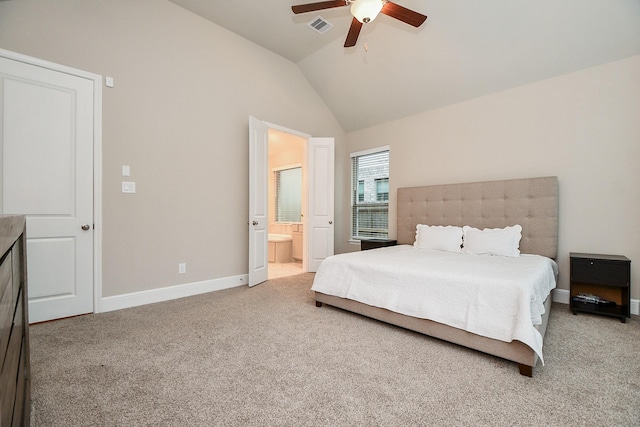 carpeted bedroom featuring ceiling fan, ensuite bath, and lofted ceiling