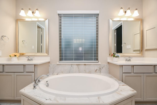 bathroom featuring a tub to relax in and vanity