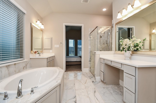 bathroom with lofted ceiling, vanity, and shower with separate bathtub