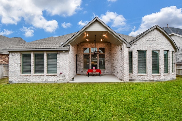 rear view of property featuring a lawn and a patio