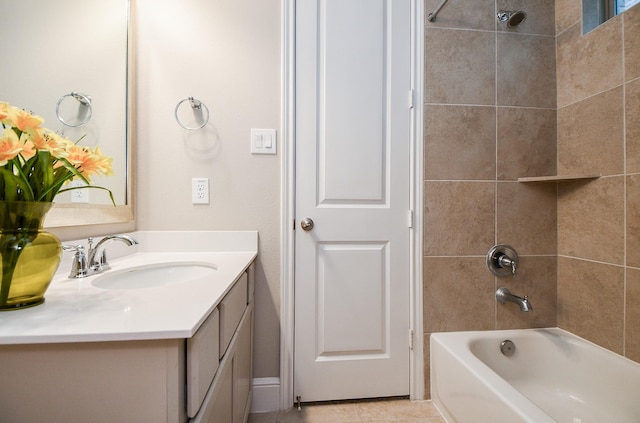 bathroom with vanity, tile patterned flooring, and tiled shower / bath