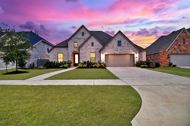 view of front facade with a garage and a lawn