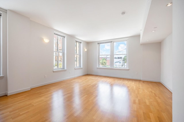 unfurnished room with light hardwood / wood-style flooring