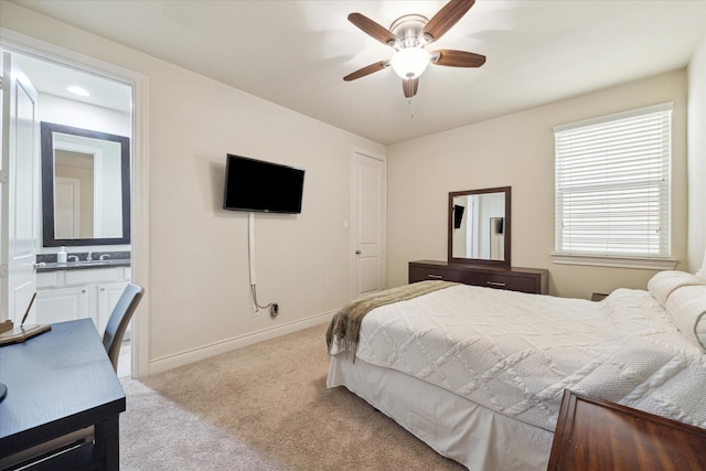 carpeted bedroom featuring sink, ceiling fan, and ensuite bathroom