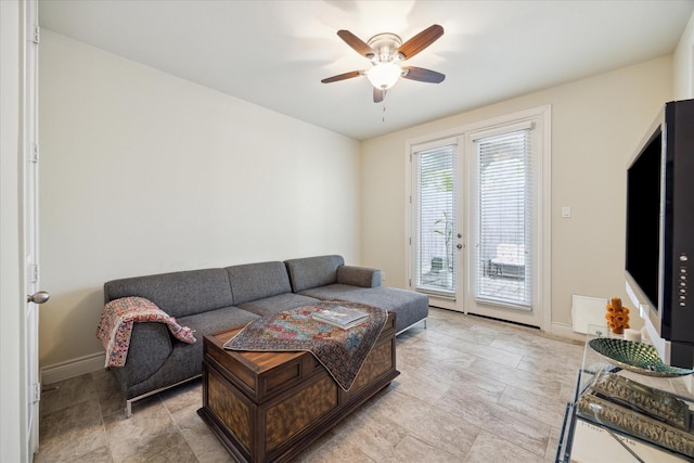 living room featuring french doors and ceiling fan