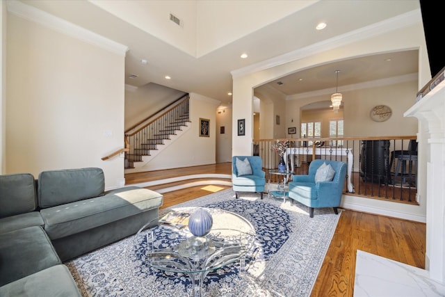 living room with crown molding and hardwood / wood-style floors