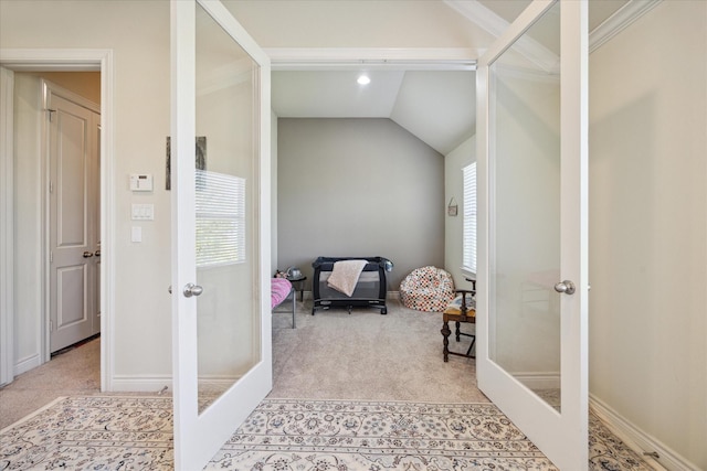 interior space featuring lofted ceiling, light carpet, and french doors