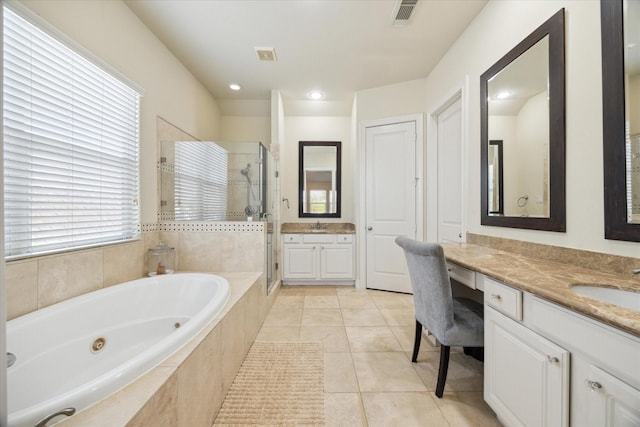 bathroom featuring vanity, independent shower and bath, and tile patterned flooring