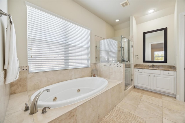 bathroom featuring tile patterned flooring, vanity, and separate shower and tub