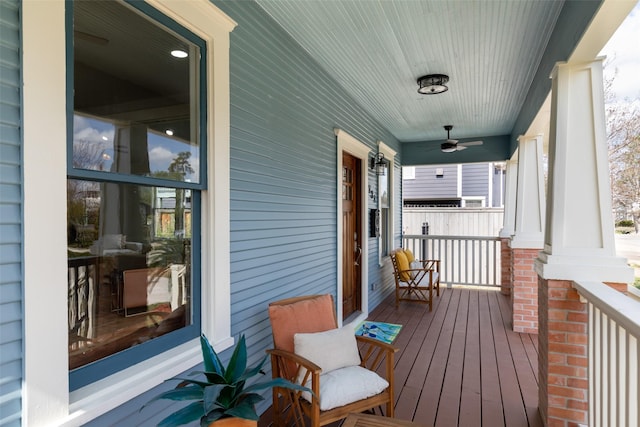 wooden deck featuring ceiling fan and covered porch