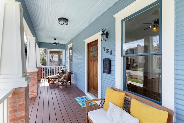 wooden deck with ceiling fan and a porch