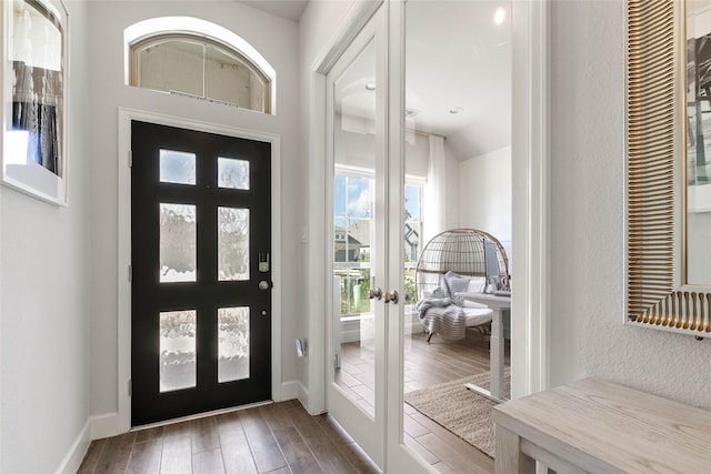 entrance foyer with french doors and dark hardwood / wood-style floors