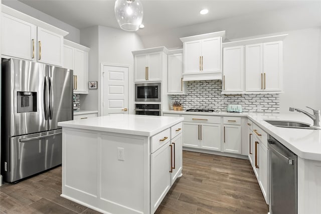 kitchen with sink, backsplash, white cabinets, and appliances with stainless steel finishes